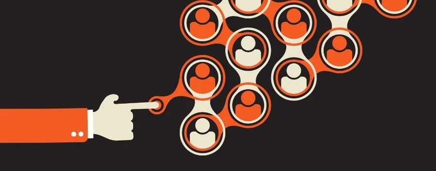 illustration of a hand holding a pair of scissors with a bunch of people in the background, with a black background